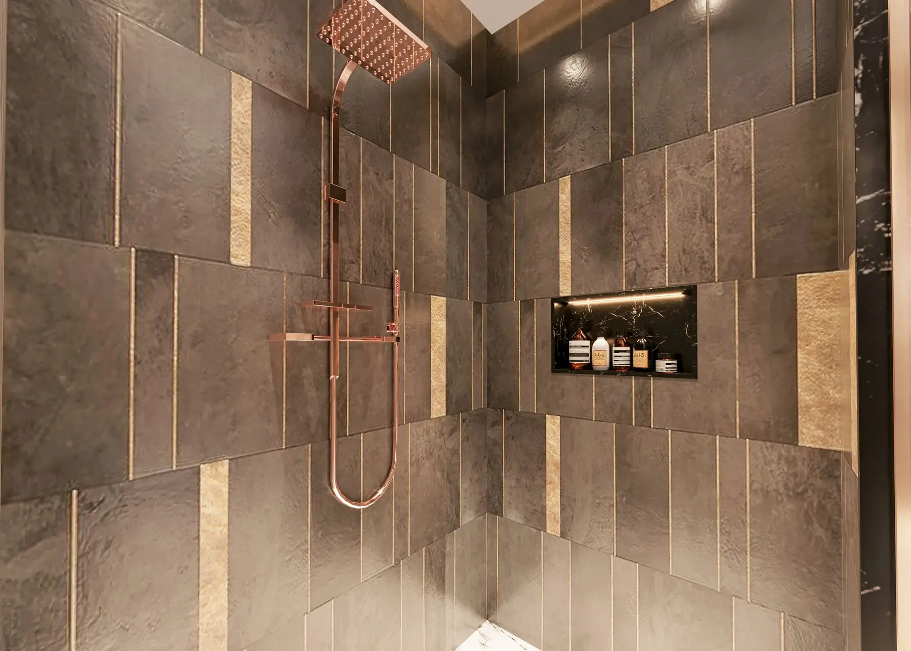 A finished shower with bronze tiling and copper fixtures